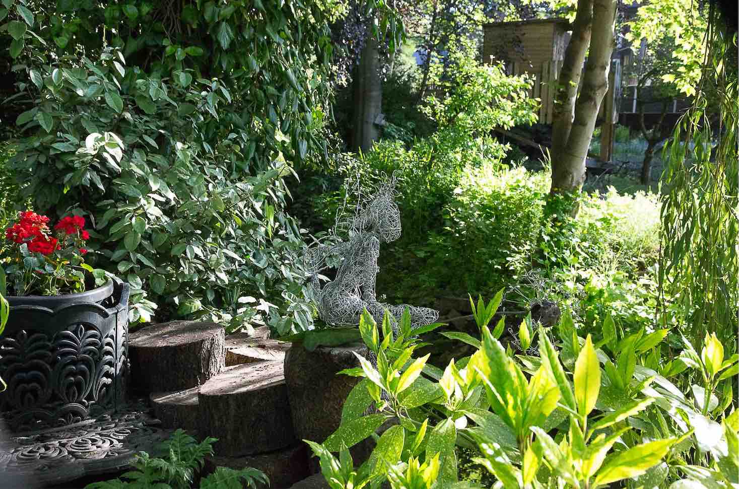 An Artful Gardener-wire figure fairy looking right into the garden colour