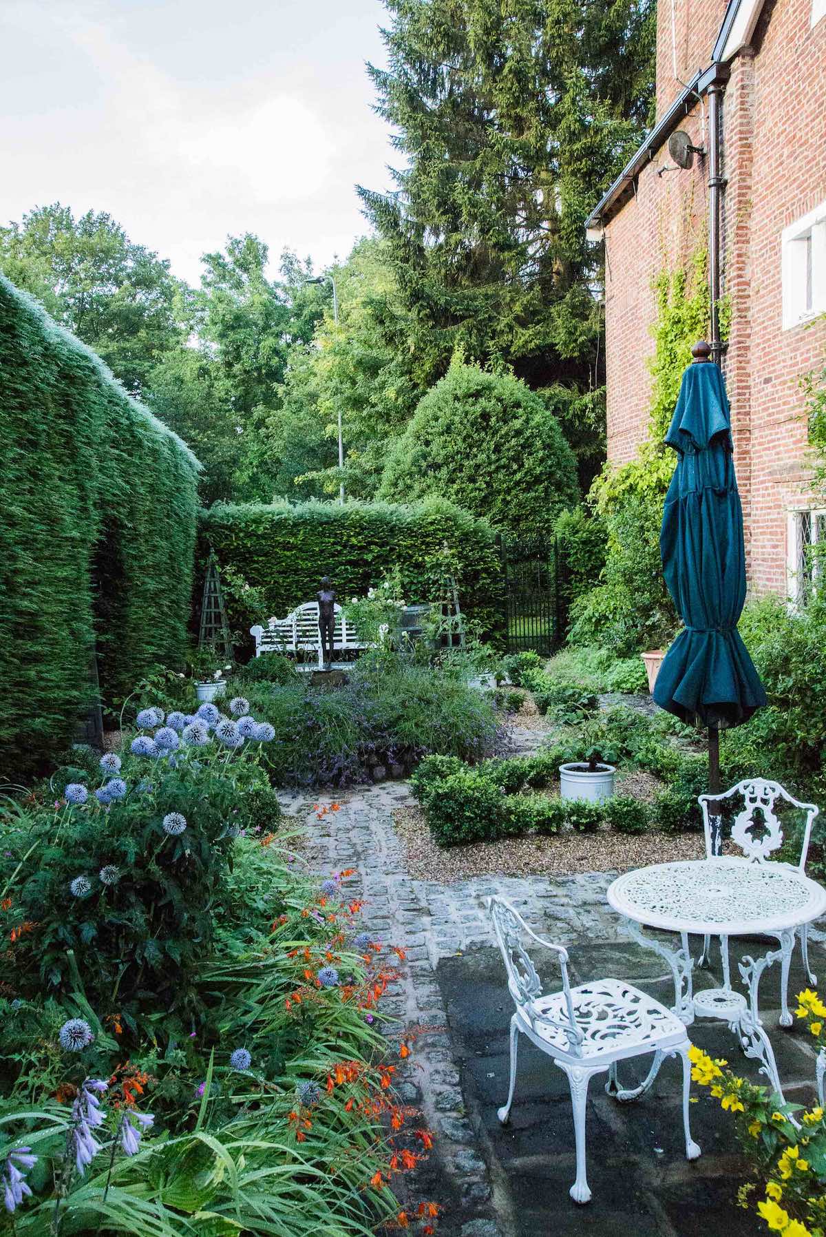 An Artful Gardener Astley Old Vicarage Gardens side of house chairs and plants