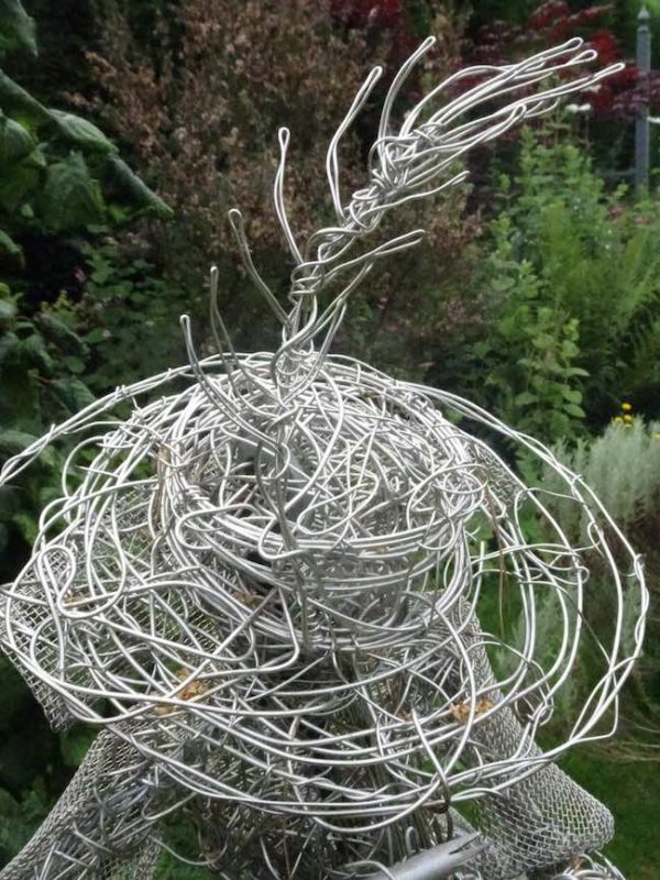 An Artful Gardener Garden Art Wire Figure Flute Player Hat and Feather detail