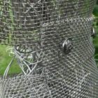 An Artful Gardener Garden Art Wire Figure Flute Player Jacket and buttons detail portrait