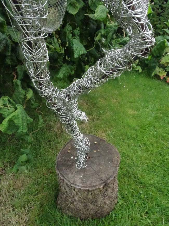 An Artful Gardener Garden Art Wire Figure Flute player legs and base portrait